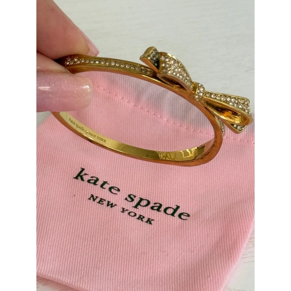 Kate Spade New York Gold Tone Pave Crystal Bow Hinged Bangle Bracelet with Bag